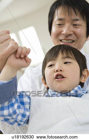 Stock Image - Photography of a father and son making promise, Low Angle View. Fotosearch