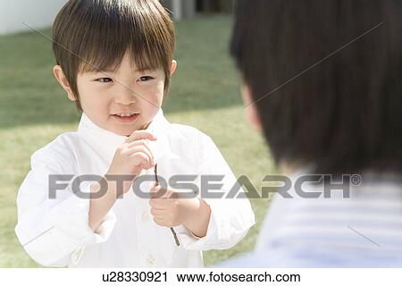 Stock Image - Photography of a father and son playing, High Angle View. Fotosearch