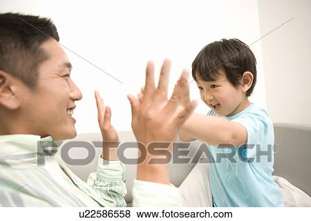 Stock Photo - Photography of a father and son playing, High Angle View. Fotosearch