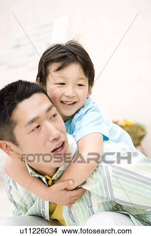 Picture - Photography of a father carrying son on back, High Angle View. Fotosearch
