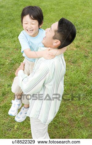 Photography of a father lifting son up, High Angle View View Large Photo Image Stock Photo - Photography of a father lifting son up, High Angle View. Fotosearch
