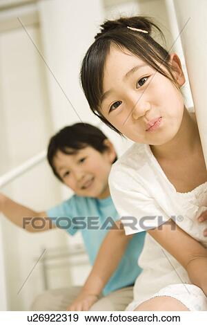 Photography of a girl and a boy smiling at camera, Low Angle View View Large Photo Image Stock Photo - Photography of a girl and a boy smiling at camera, Low Angle View. Fotosearch