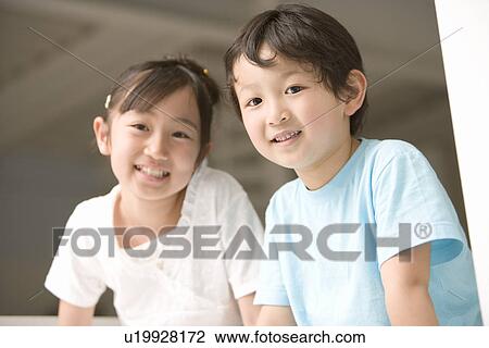 Photography of a girl and boy smiling at camera, Low Angle View View Large Photo Image Stock Image - Photography of a girl and boy smiling at camera, Low Angle View. Fotosearch