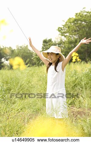 Stock Photography - Photography of a girl and flowers, Low Angle View. Fotosearch