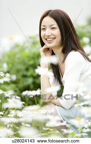 Photography of a mid adult woman surrounded by flowers, Differential Focus View Large Photo Image Stock Image - Photography of a mid adult woman surrounded by flowers, Differential Focus. Fotosearch