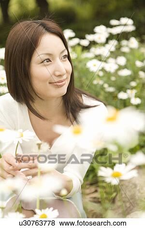 Photography of a woman surrounded by flowers, High Angle View View Large Photo Image Stock Photo - Photography of a woman surrounded by flowers, High Angle View. Fotosearch