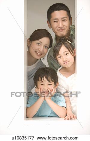 Photography of parents and children smiling at camera through the window, Front View View Large Photo Image Stock Photo - Photography of parents and children smiling at camera through the window, Front View. Fotosearch