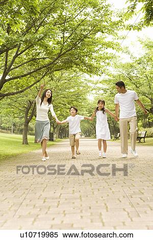 Photography of parents and children walking in the park, Low Angle View View Large Photo Image Stock Photography - Photography of parents and children walking in the park, Low Angle View. Fotosearch