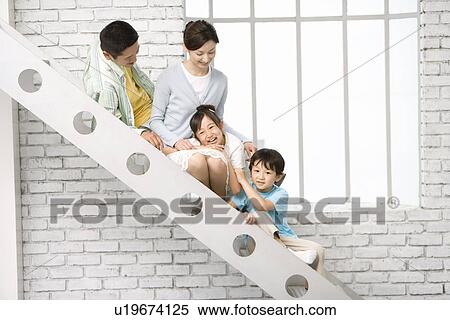 Stock Photography - Photography of parents and children sitting on stairs, Side View. Fotosearch