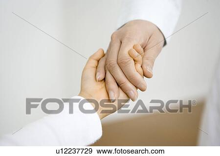 Stock Photo - Photography of parent's hand holding child's hand, Close Up. Fotosearch