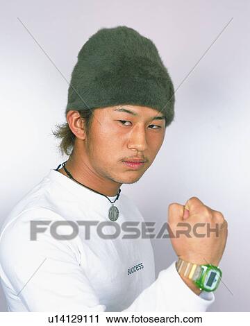 Portrait of Young Man Smiling, Clenching His Fist, Front View View Large Photo Image Stock Image - Portrait of Young Man Smiling, Clenching His Fist, Front View . Fotosearch