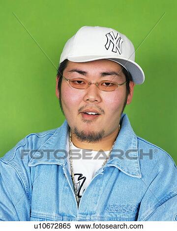 Stock Photography - Portrait of Young Man Smiling, Wearing Sunglasses, Front View . Fotosearch