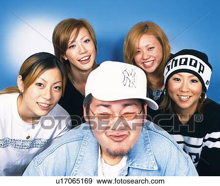 Stock Photo - Portrait of Young People Posing, Making a Face, Front View. Fotosearch