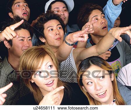 Stock Image - Portrait of Young People Posing with Finger in Air, Making a Face, High Angle View, Full Frame. Fotosearch