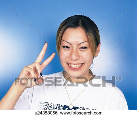Portrait of Young Woman Making Peace Signs, Front View View Large Photo Image Stock Photograph - Portrait of Young Woman Making Peace Signs, Front View. Fotosearch