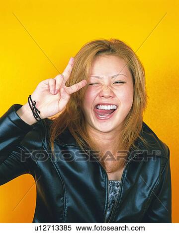 Portrait of Young Woman Making Peace Signs, Front View View Large Photo Image Stock Photography - Portrait of Young Woman Making Peace Signs, Front View. Fotosearch