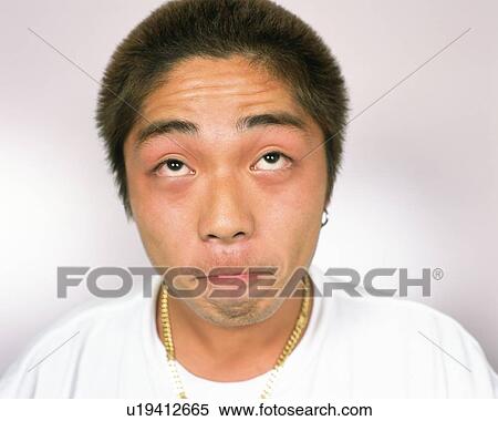 Stock Photography - Young Man Making a Face, Portrait, Front View. Fotosearch