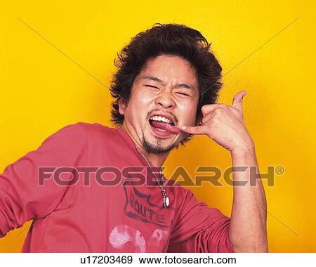 Young Man Making a Face, Smiling, Portrait, Front View View Large Photo Image Stock Photo - Young Man Making a Face, Smiling, Portrait, Front View. Fotosearch