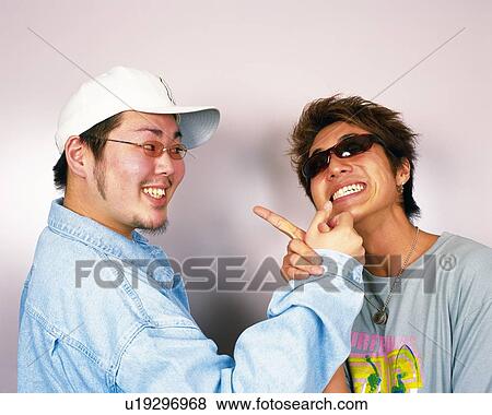Young Men Making a Face and Holding Hands, Portrait, Front View View Large Photo Image Stock Photo - Young Men Making a Face and Holding Hands, Portrait, Front View. Fotosearch