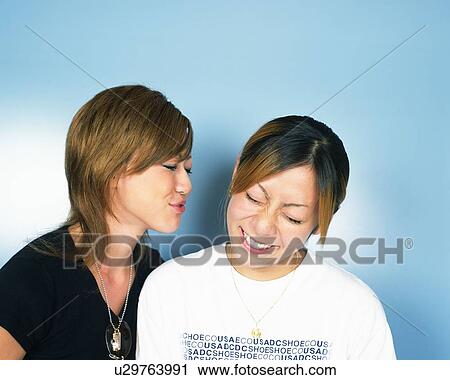 Young Woman Blowing On Young Woman's Ear View Large Photo Image Stock Image - Young Woman Blowing On Young Woman's Ear. Fotosearch