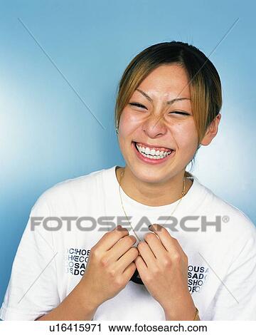 Stock Image - Young Woman Smiling, Portrait, Front View . Fotosearch