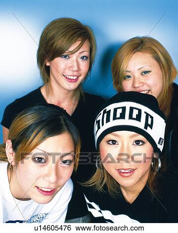 Stock Photograph - Young Women Smiling, Portrait, One Woman Wearing Knit Cap, Front View . Fotosearch
