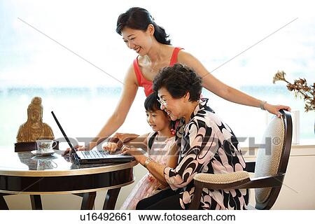 A small girl learning on laptop through her grandmother. View Large Photo Image Stock Image - A small girl learning on laptop through her grandmother.. Fotosearch