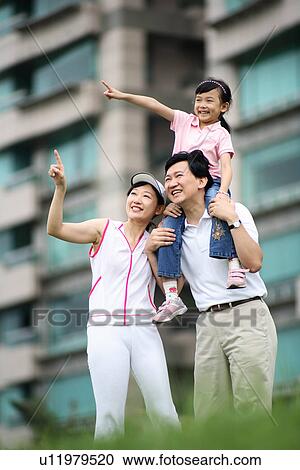 Low angle view of a happy family. View Large Photo Image Stock Image - Low angle view of a happy family.. Fotosearch