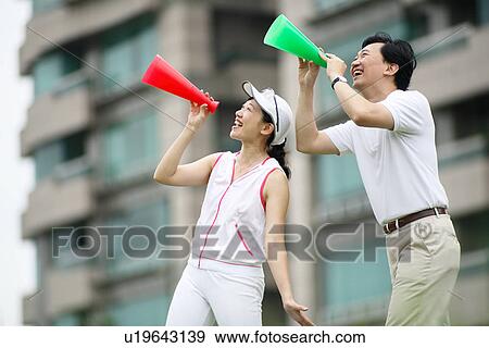 View of a couple holding megaphones. View Large Photo Image Stock Photo - View of a couple holding megaphones.. Fotosearch