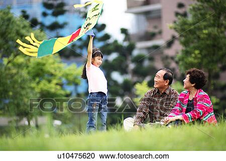 Stock Image - View of a couple sitting in a garden.. Fotosearch