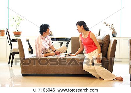 View of a couple sitting together. View Large Photo Image Stock Photograph - View of a couple sitting together.. Fotosearch