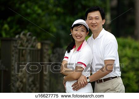 Stock Photography - View of a couple smiling in garden.. Fotosearch