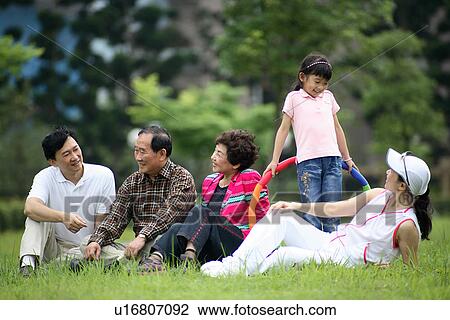 View of a family enjoying at the park. View Large Photo Image Stock Image - View of a family enjoying at the park.. Fotosearch