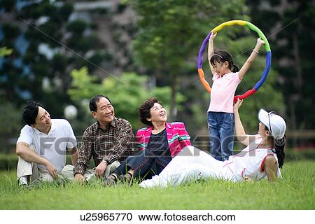 Stock Image - View of a family enjoying at the park.. Fotosearch