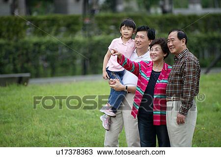 View of a family in a park. View Large Photo Image Stock Image - View of a family in a park.. Fotosearch
