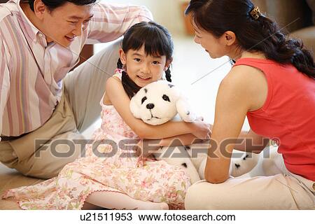 Stock Image - View of a family sitting together.. Fotosearch