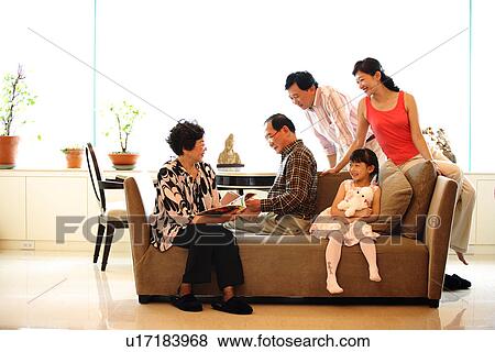 View of a family sitting together. View Large Photo Image Stock Photo - View of a family sitting together.. Fotosearch