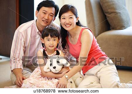 Stock Photo - View of a family sitting together.. Fotosearch