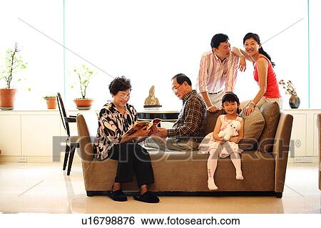 Stock Photograph - View of a family sitting together.. Fotosearch