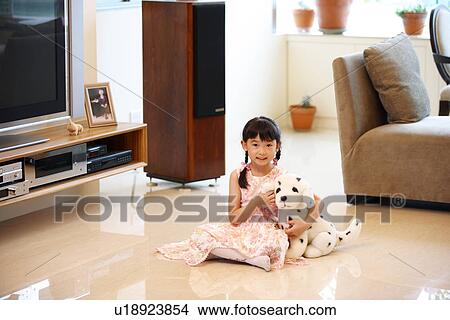 View of a girl child playing with her toy. View Large Photo Image Picture - View of a girl child playing with her toy.. Fotosearch