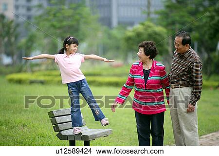 Picture - View of a girl playing on the bench.. Fotosearch