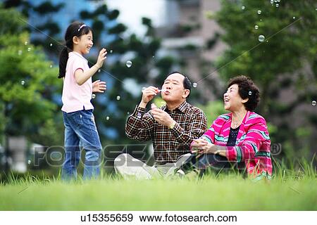 View of a girl playing with bubbles. View Large Photo Image Stock Photo - View of a girl playing with bubbles.. Fotosearch