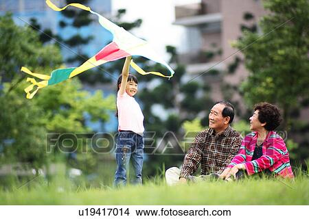 Picture - View of a girl playing with kite.. Fotosearch