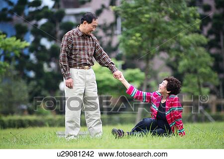 Stock Image - View of a senior couple in the park.. Fotosearch