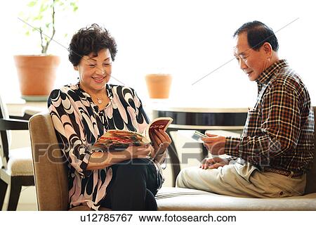 View of a senior couple sitting on the sofa. View Large Photo Image Stock Photo - View of a senior couple sitting on the sofa.. Fotosearch
