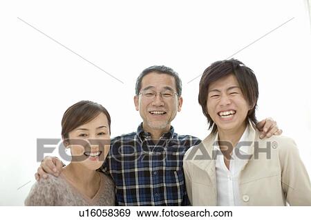 Stock Photo - A Family Smiling at Camera, Front View, Portrait. Fotosearch