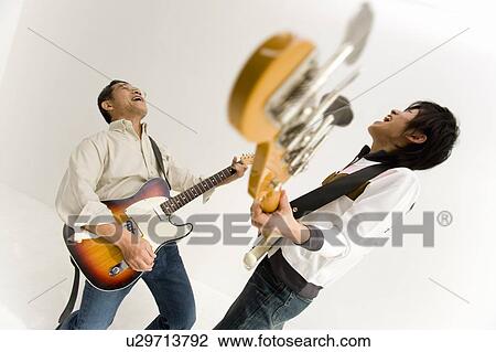 A Father and His Son Playing Guitars Together, Side View, Studio Shot, Differential Focus View Large Photo Image Stock Image - A Father and His Son Playing Guitars Together, Side View, Studio Shot, Differential Focus. Fotosearch