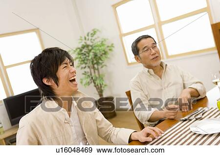 A Father and His Son Smiling at a Table, Front View, Side View, Differential Focus View Large Photo Image Stock Photo - A Father and His Son Smiling at a Table, Front View, Side View, Differential Focus. Fotosearch