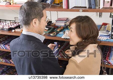 A Mature Adult Couple Choosing a Tie, Side View, Rear View, High Angle View View Large Photo Image Stock Photo - A Mature Adult Couple Choosing a Tie, Side View, Rear View, High Angle View. Fotosearch