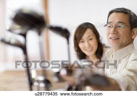 A Mature Adult Couple Looking at a Golf Club Together, Front View, Side View, Differential Focus View Large Photo Image Stock Photography - A Mature Adult Couple Looking at a Golf Club Together, Front View, Side View, Differential Focus. Fotosearch